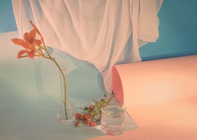 Close-up of rose bouquet in glass vase on table