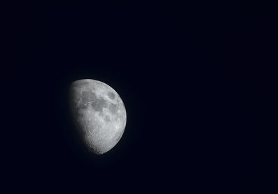 Low angle view of moon against clear sky at night