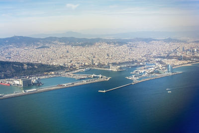 High angle view of sea by buildings against sky