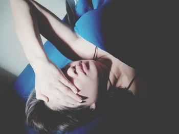 Close-up of woman relaxing on bed