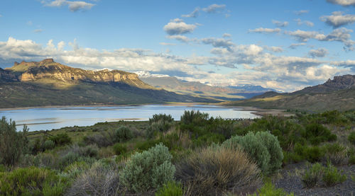 Scenic view of lake and mountains against sky