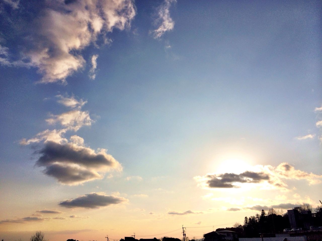 sunset, sky, silhouette, cloud - sky, scenics, beauty in nature, building exterior, tranquility, tranquil scene, low angle view, cloud, nature, built structure, architecture, sun, sunlight, blue, outdoors, idyllic, orange color