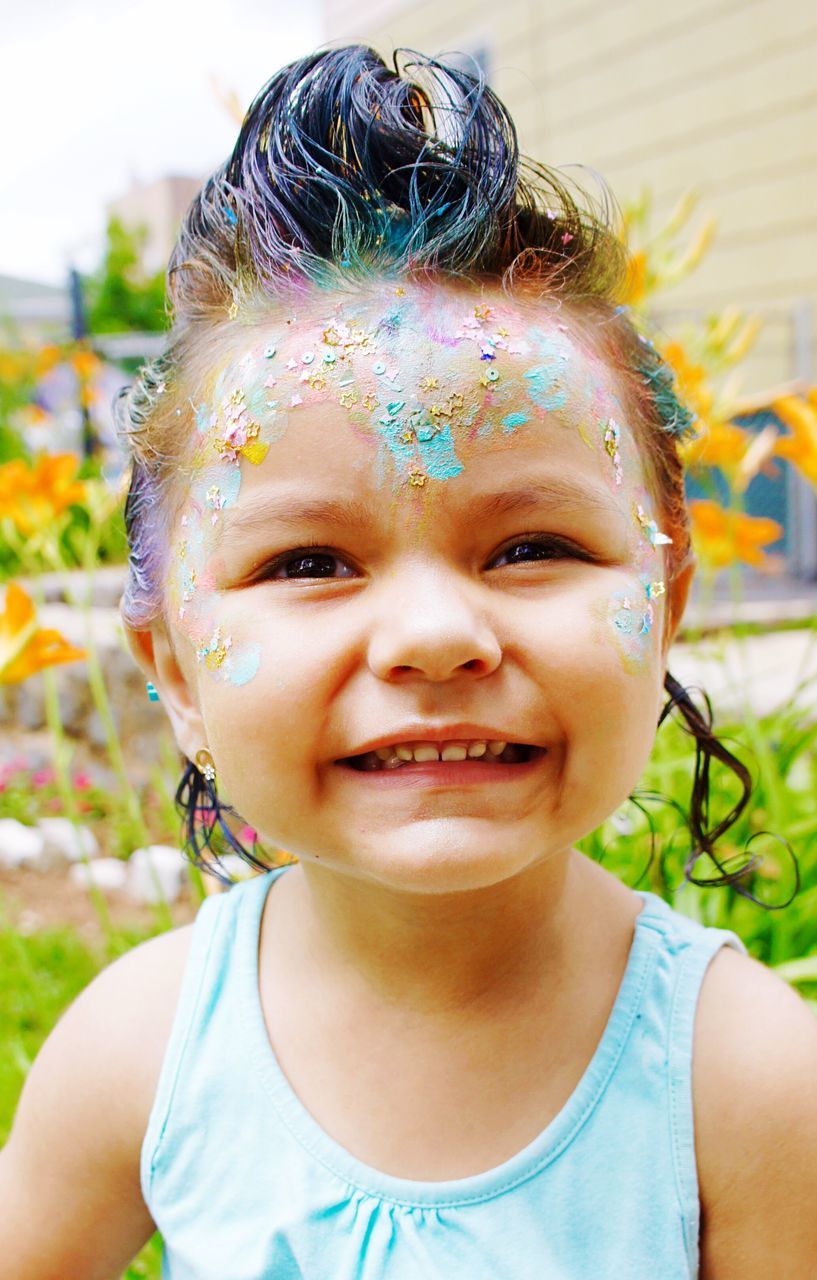 childhood, looking at camera, real people, happiness, front view, smiling, elementary age, focus on foreground, lifestyles, portrait, girls, outdoors, leisure activity, celebration, one person, day, close-up