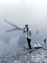 Full length of man standing on snow against sky