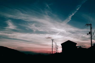 Low angle view of silhouette building against sky