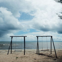 Lifeguard hut on beach against sky