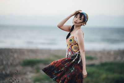 Young woman standing at beach