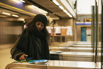 Woman paying for subway ticket with smart phone