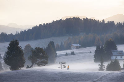 Scenic view of snow covered mountain against clear sky during sunset