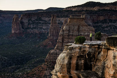 A young woman enjoys a view over colorado national monument in co.