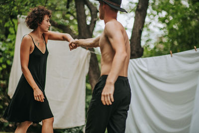 Rear view of couple holding hands