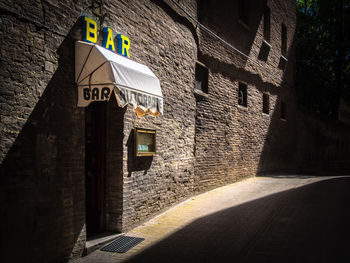 Road sign on wall of building