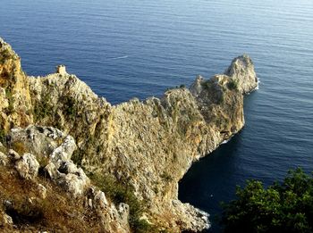 High angle view of rocks by sea