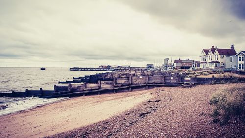 View of beach against cloudy sky