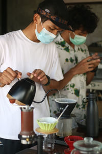 Rear view of man working on table