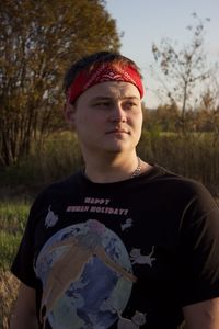 Portrait of young man standing on land