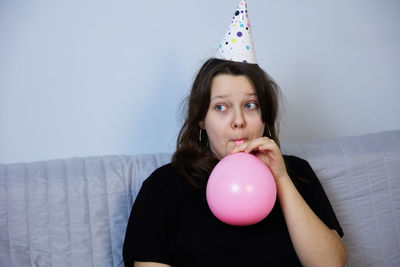 Children have fun playing, blowing up colorful balloons, at a birthday party