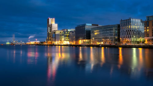 Illuminated city at waterfront