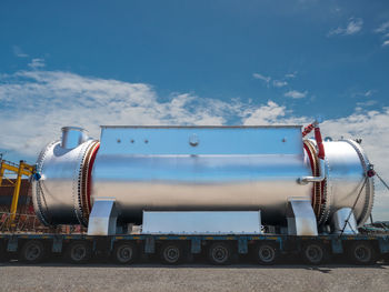 The pressure boiler tank is loading on a special truck at the port and move to industrial factory.