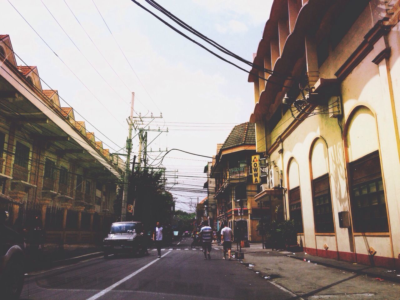 building exterior, architecture, built structure, street, sky, city, power line, transportation, building, residential building, residential structure, car, city street, road, the way forward, cable, low angle view, land vehicle, city life, house