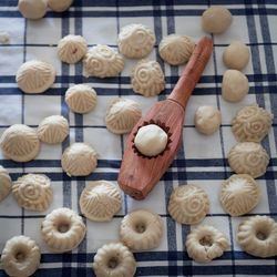 High angle view of maamouls and wooden cookie cutter on table