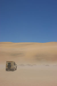 View of landscape against clear blue sky