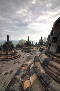 Old ruin temple against cloudy sky