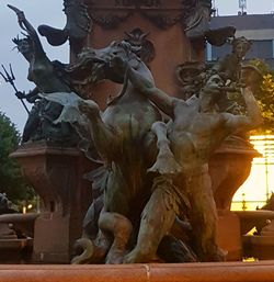 Low angle view of statues against sky