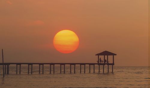 Scenic view of sea against orange sky