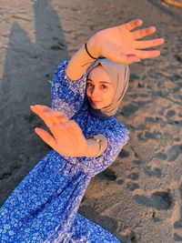 Portrait of young woman standing at beach