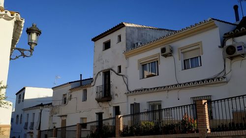 Low angle view of buildings against clear blue sky