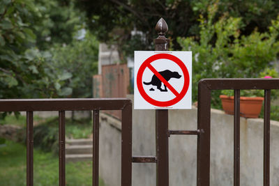 Information sign on metal fence