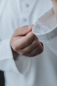 Close-up of hand holding white sleeve