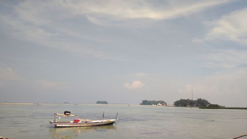 Boat sailing in sea against sky