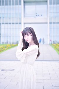 Portrait of a beautiful young woman standing outdoors