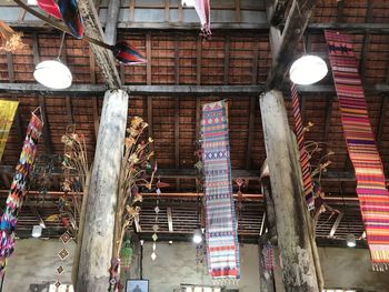 Low angle view of illuminated lights hanging from ceiling of building