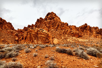 Rock formation on landscape against sky