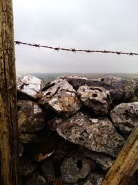 Barbed wire against sky