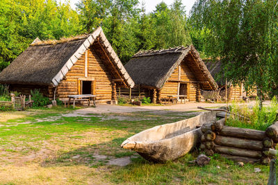 View of wooden house and trees on landscape