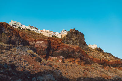 Low angle view of mountain against clear blue sky