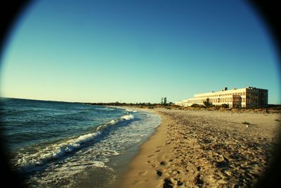 Scenic view of beach against blue sky