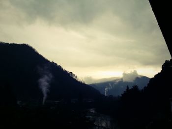 Scenic view of mountains against cloudy sky