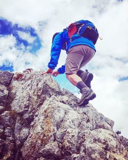 Low angle view of man standing on rock