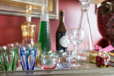 Wine bottles and glasses on table at home