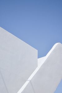 Low angle view of white building against clear blue sky