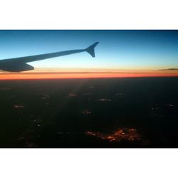 Cropped image of airplane flying over landscape