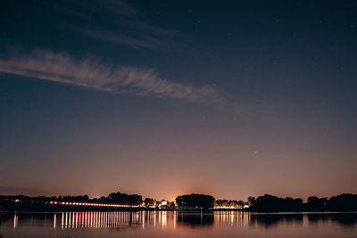 Scenic view of lake against sky at night