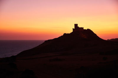 Scenic view of sea against orange sky