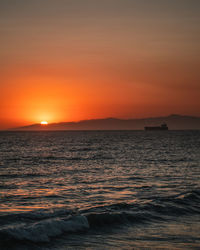 Scenic view of sea against romantic sky at sunset