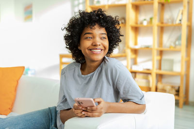 Portrait of young woman using mobile phone